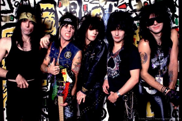 L.A. Guns are an American glam metal band whose music is frequently associated with the L.A. glam metal scene which grew up around the Sunset Strip in the 1980s, in particular the sleaze rock subgenre. Guns N' Roses, which once featured three of the original L.A. Guns members, was the most prominent exponent of this subgenre, generally preferring an anti-social image to elaborate make-up and costumes. Today two bands share and tour using the L.A. Guns name: One is headed by Tracii Guns, the founder of the original band, and the other is headed by Phil Lewis and Steve Riley, the singer and drummer of the most successful incarnation of the band.  History  Founding (1983-1984) In 1983, Tracii Guns formed the band known as L.A. Guns with singer Michael Jagosz, bassist Ole Beich, and drummer Rob Gardner.  Reformation (1985) The second lineup of L.A. Guns was formed by Mau Maus and The Joneses drummer Paul Mars Black, who switched to lead vocals, and guitarist Mick Cripps, who switched to bass. They teamed up with drummer Nickey "Beat" Alexander, who was jamming with guitarist Tracii Guns. This lineup is considered to be the original version of the band. Originally this group was going to call itself Faster Pussycat, a name brought in by Paul Black and Mick Cripps. After much debate, this new group re-adopted the name L.A. Guns in order to utilize the backing and promotional material left over from the former lineup which had been disbanded for over a year. Tracii left L.A. Guns at the end of the year to play with a Penthouse Pet who was signed with Atlantic Records. He moved to New York and informed the band he would not be returning right before their record label showcase at the Troubadour in Hollywood. Guns N' Roses were called to fill in for the guitar-less L.A Guns and played to a sold out L.A. Guns crowd. Shortly after this show, GNR inked a record deal with Geffen Records.  Paul Black leads L.A. Guns (1985-1986) After Tracii left the band, Paul Black recruited ex-Dogs D'Amour singer Robert Stoddard to be the new guitarist. This lineup quickly picked up where they left off. They demoed and gigged in 1985 and 1986, with Black contributing most of the material that would be recorded on their debut album. Several record labels were already interested in signing this line-up but the band wanted a fuller sound. At the end of 1986, after his stint with the former Penthouse model fell apart, Tracii was brought back in to make L.A. Guns a five piece band for the first time. A record deal with Polygram Records was secured after Paul introduced a song called "Love and Hate." The label wanted this to be the first single. However, the new five piece line up would not survive.  Paul was replaced by Phil Lewis of the British band Girl. Mick then switched back to guitar, replacing Robert, and former Faster Pussycat member Kelly Nickels was added on bass. L.A. Guns then recorded their eponymous first album, released in 1988 on Vertigo Records. The gold award debut album spawned the singles "One More Reason" and "Sex Action," both written by Black. "Sex Action" evolved from Black's earlier song "Love and Hate." Black also contributed "No Mercy," "Nothing to Lose," "Bitch Is Back," "One Way Ticket," and "Winter's Fool" to the first record and "Never Enough," the first single off the second album, Cocked and Loaded. Black also made many other contributions to the L.A. Guns repertoire which would later appear on a record called Black List, which features Black singing the original L.A. Guns songs with the original band, recorded during his time in the band.
